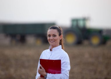 Agronomist in field during corn harvest clipart