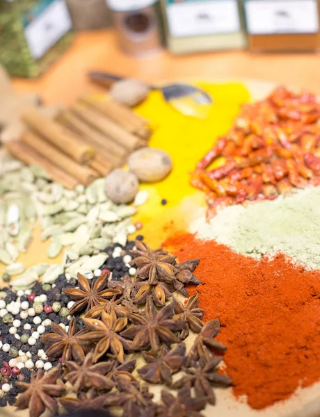 Colorful spices on wooden plate — Stock Photo, Image