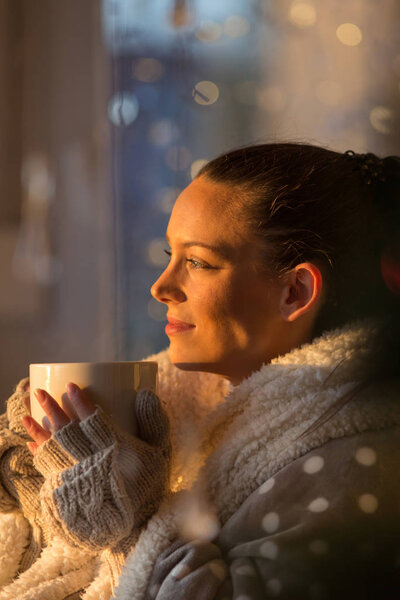 Girl with cup of coffee in christmas ambient