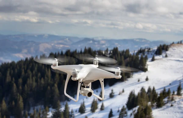 Drone flying above mountain top in winter — Stockfoto