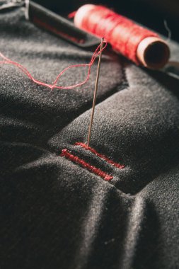 Red thread on gray textile