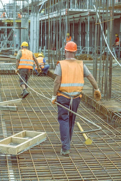 Trabajadores de la construcción que llevan barra de acero pesada 4 — Foto de Stock