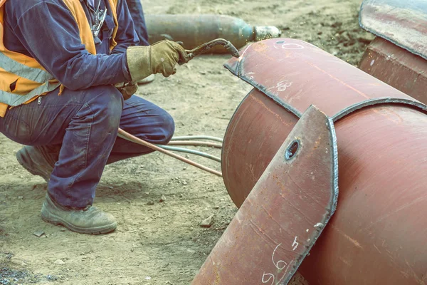 Welder Welding Heat Pipes In Trench. Weldin Insulated Pipes To