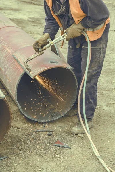 Welder Welding Heat Pipes In Trench. Weldin Insulated Pipes To