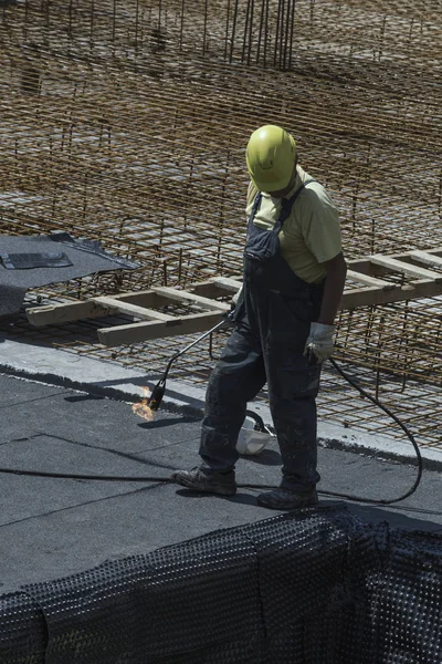 Insulation worker with blowtorch 3