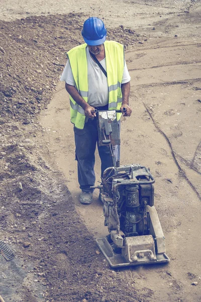 Builder worker use vibrating plate compactor 3 — Stock Photo, Image