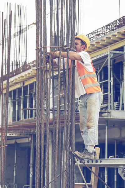 Worker tying reinforcing steel bars with plier and wire 3 — Stock Photo, Image