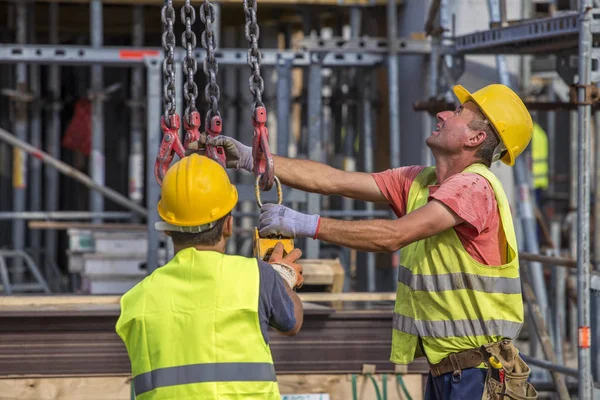 Trabajadores de la construcción se preparan para levantar el molde pilar de hormigón — Foto de Stock