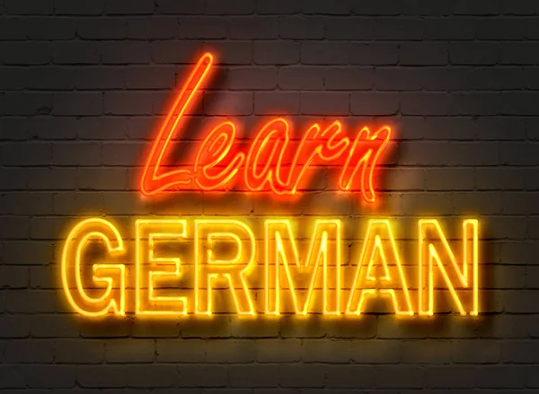 Learn German, neon sign on brick wall — Stock Photo, Image