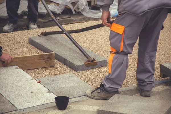 Builder workers lay large paving slabs 2 — Stock Photo, Image