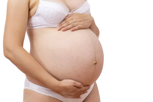 Vista cortada da mulher grávida em roupa interior segurando sua barriga — Fotografia de Stock