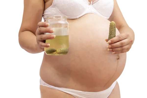 Pregnant woman holding pickled cucumber and jar — Stock Photo, Image