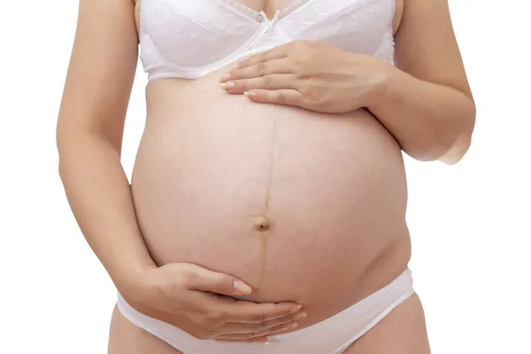 Mulher grávida em roupa interior segurando sua barriga — Fotografia de Stock