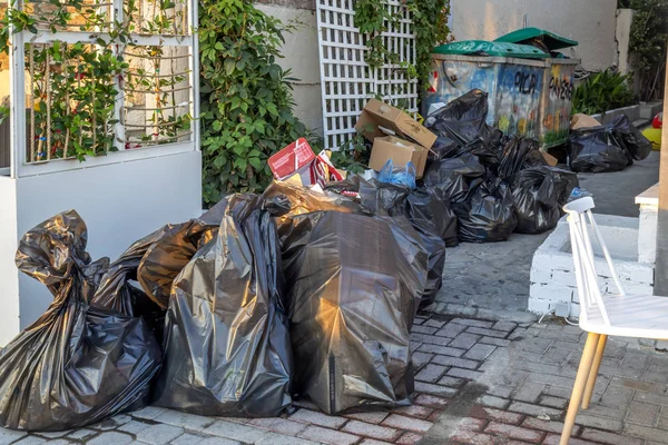 Black trash plastic bags on the pavement — Stock Photo, Image