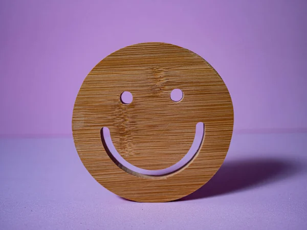 HAPPINESS IN WOOD ON PINK BACKGROUND