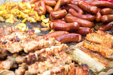 Et kebabı, sosis, büyük bir tavada kızartılmış rustik tarzda patates. Fast food konsepti, sokak restoranları ve fuarlar.