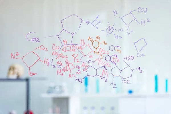 The scientists, chemists, discover the chemical formula write on whiteboard in laboratory. The researcher discover vaccine or drug for treatment patients infected COVID19.
