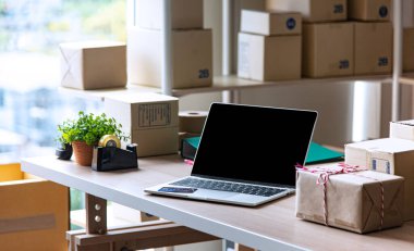 Sme çevrimiçi işleri için malzemeler, teslimat işi dizüstü bilgisayarı, barkod, kutular, hisse senetleri ve paketlerdeki ürünleri kontrol etmek. Ev ofisinde çalışan küçük işletmeler..