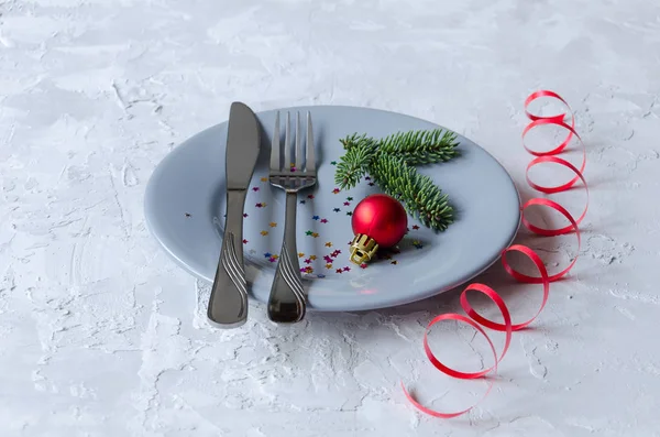Grey plate, knife and fork. New year and Christmas table setting. — Stock Photo, Image