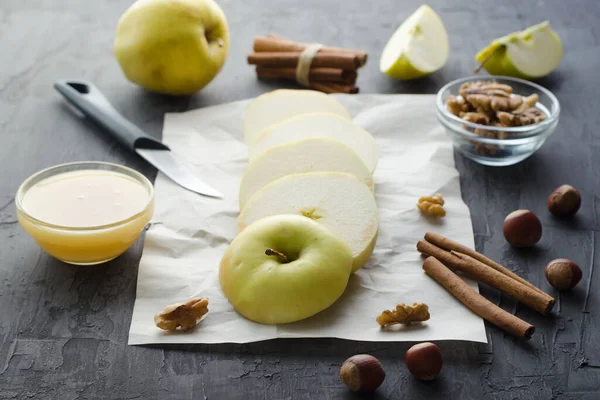 Snijd groene appel met honing en noten op verfrommeld papier — Stockfoto