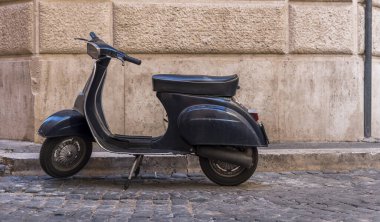 Roma 'nın eski duvarına karşı klasik scooter manzarası. Scooter, İtalya 'nın başkentindeki ana ulaşım araçlarından biridir..