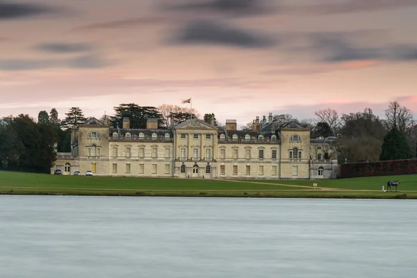 Woburn Abbey, İngiltere 'de, günbatımında. Uzun pozlama, su ve bulutları bulanıklaştırır.