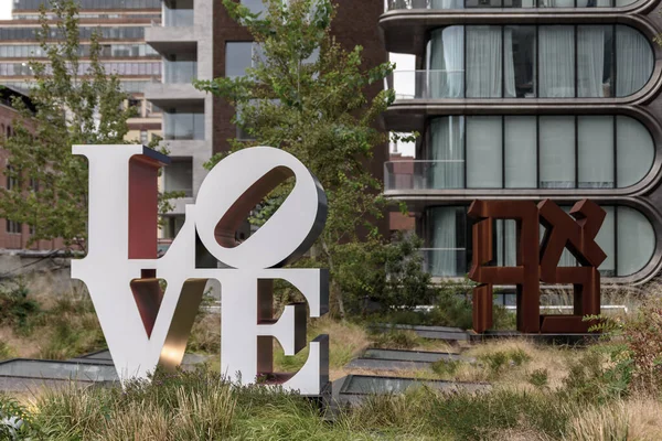 Sculpture spelling out the word \'LOVE\', located near a public park in New York City