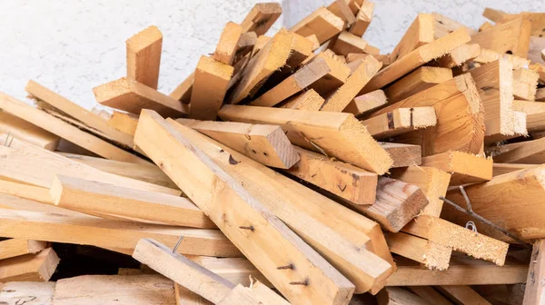 Pile of scrap wood from mattresses and palettes for recycled (up-cycled) DIY furniture making or wood carpentry projects. Wood cuts for practice or rustic craft ideas. Environmental resource saving. — Stock Photo, Image
