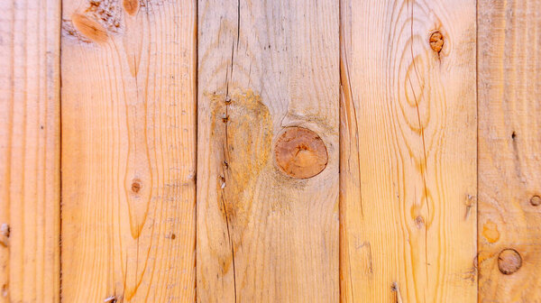 Plain fresh recycled wood background in panels, showing wood grain and nuts, with imperfections.  Copy space and slightly blurred background, with a rustic style. Wood has not been weathered.