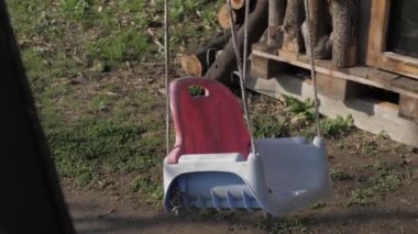 Yalnız bebek evin bahçesinde sallanıyor.