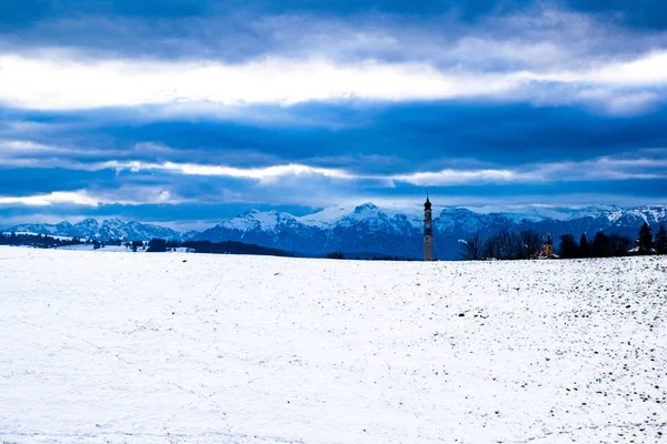 Campanile nuvole e montagne — Foto Stock