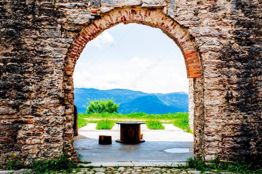 ancient walls rich in history, bricks and stones, arched doors and windows open glimpses of mountain landscapes, Forte Interrotto, Asiago, Vicenza, Veneto, Italy