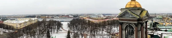 St. Petersburg, Russia, February 2020. Angels of St. Isaac`s Cathedral and a view of the city.
