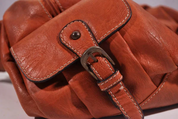 Brown leather bag storage compartment.Leather belt strap.