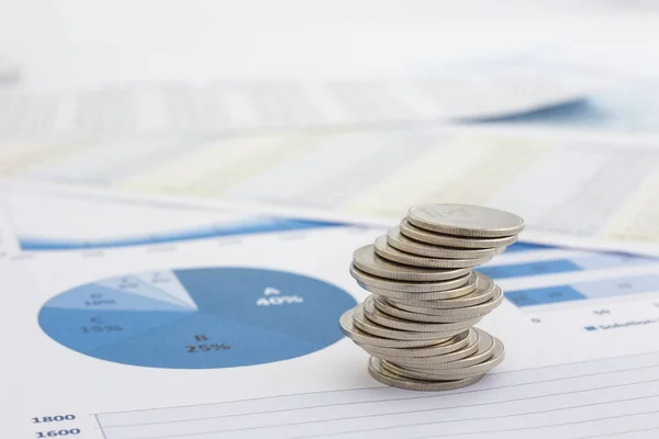 Stack of coins and charts — Stock Photo, Image