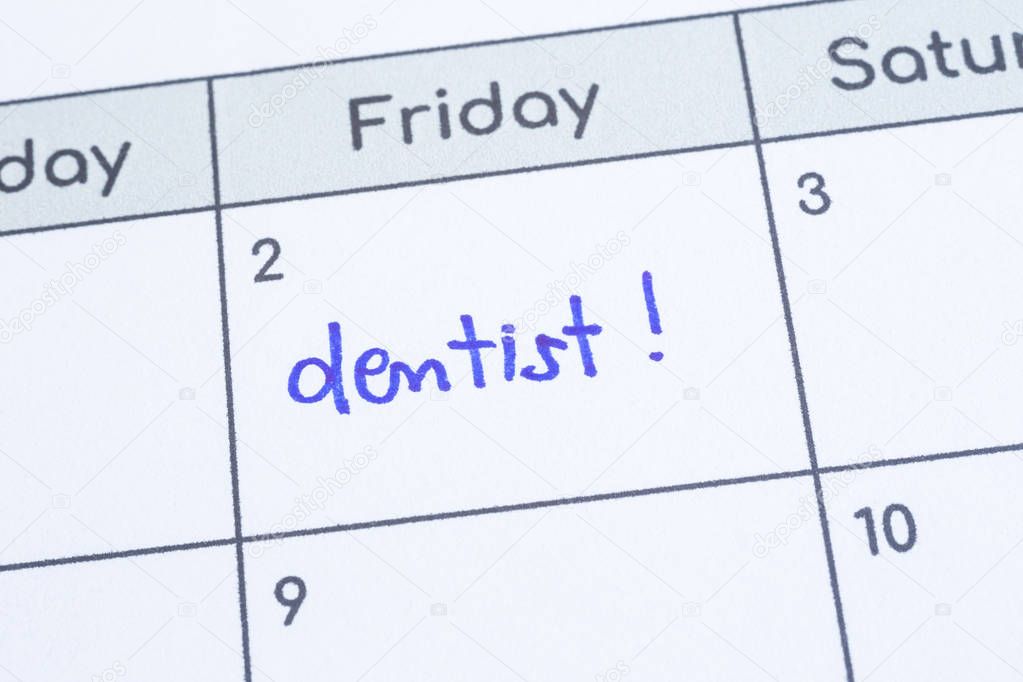 The word Dentist written on calendar page. 