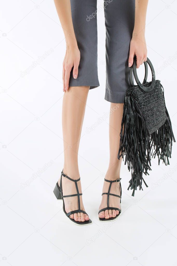 female legs in stylish shoes, elegance and femininity on a white background