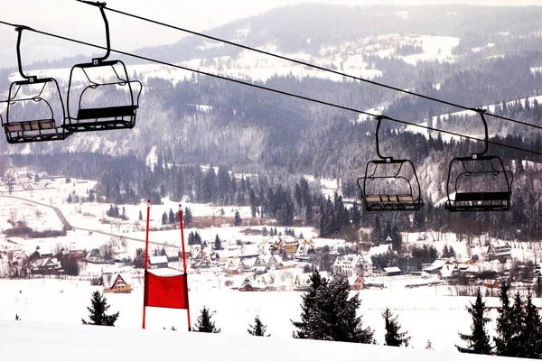 empty ski lift with a red slalom goal for slalom competition