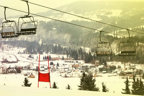 empty ski lift with a red slalom goal for slalom competition