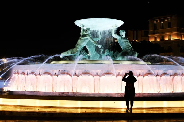 一位年轻女子带着三个十进制照明喷泉的照片 马耳他瓦莱塔的地标 夜间射击 — 图库照片