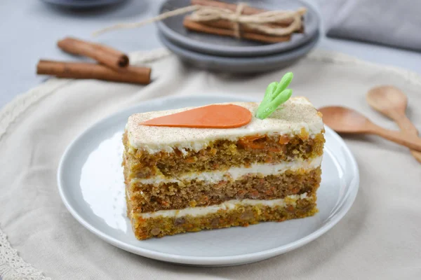 Carrot cake for mother\'s Day.  Layer cake with grated carrots, walnuts and dried apricots, topped with cream cheese and frosting. A delightful pleasure to relax.National holiday.  Close-up, copyspace, top view.