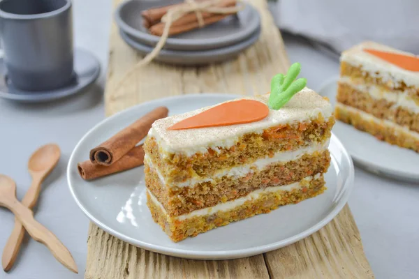 Carrot cake for mother\'s Day.  Layer cake with grated carrots, walnuts and dried apricots, topped with cream cheese and frosting. A delightful pleasure to relax.National holiday.  Close-up, copyspace, top view.