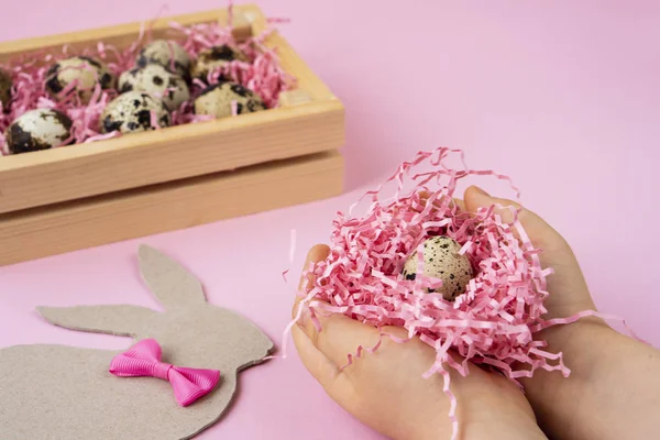 Easter Eggs Wooden Box Hands Holding Nest Egg Pink Background — Stock Photo, Image