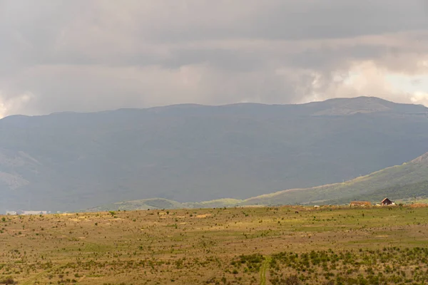 The top of the mountain valley. Mountains before the rain, gray sky covered with clouds. Mountain landscape.