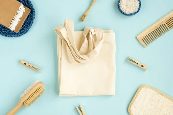 Zero Waste Cotton Bag. Zero Waste Set For Bathing On A Light Blue Background.   Natural sisal brush, wooden comb, sea salt, bamboo toothbrush, washcloth and cotton swabs.  Top view, flat lay