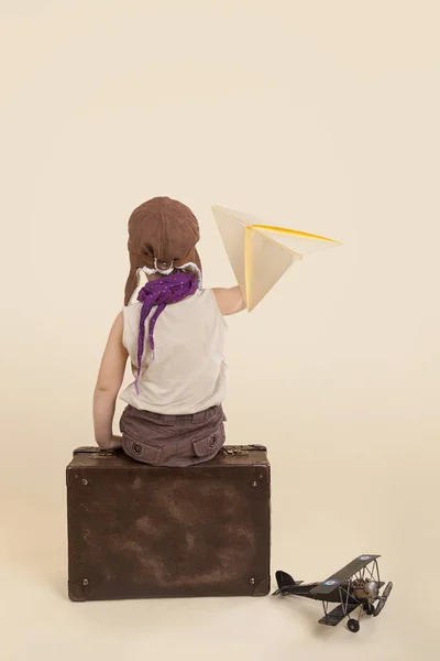 Kid holding paper airplane. — Stock Photo, Image