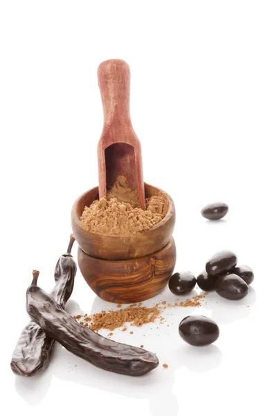 Carob powder and beans and candy isolated. — Stock Photo, Image