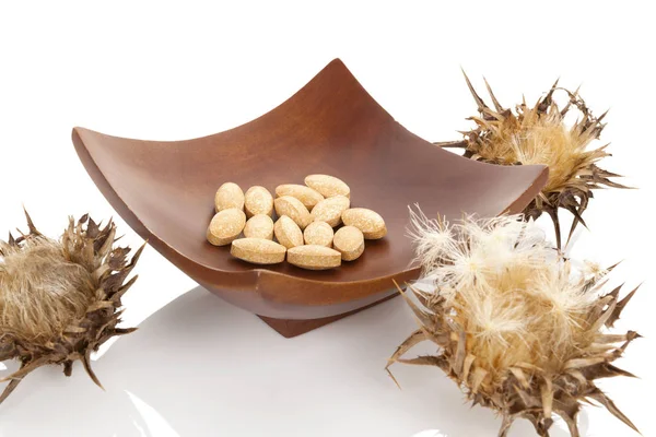 Dried milk Thistle plant with milk thistle pills — Stock Photo, Image