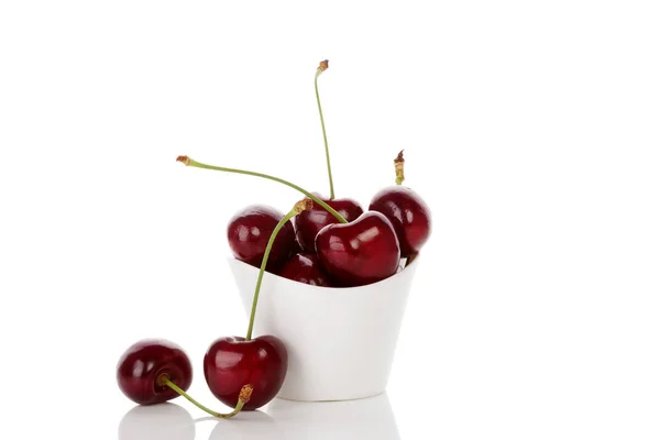 Delicious cherries in cup isolated. — Stock Photo, Image
