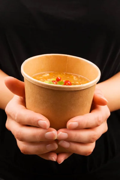 Woman holding hot and sour soup in eco cup. — 图库照片